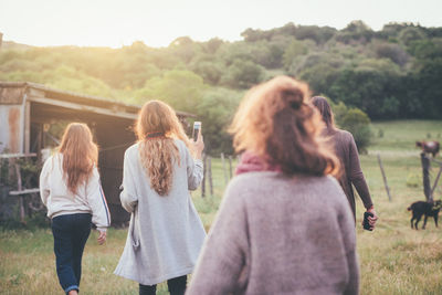 Rear view of people standing on landscape