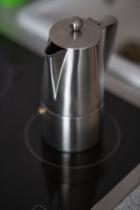 High angle view of metallic jug on stove at home
