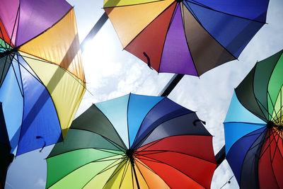 Low angle view of umbrella against blue sky