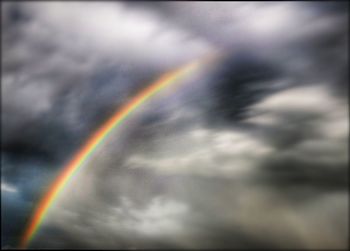 Scenic view of rainbow over cloudy sky