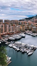 High angle view of marina and buildings against sky