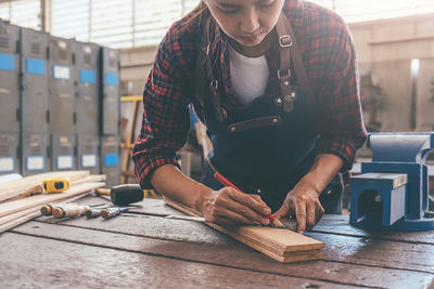 Midsection of woman working on table