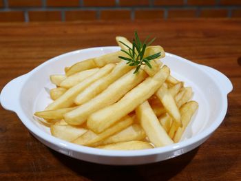 Close-up of burger and fries in plate on table