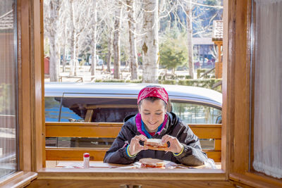 Portrait of woman sitting on table in restaurant