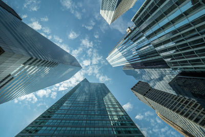 Directly below shot of modern buildings against sky in city
