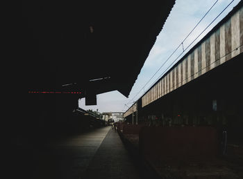 Road amidst buildings against sky