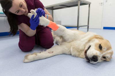 Young woman with dog relaxing on floor