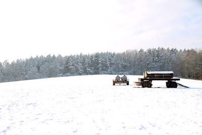 View of snow on field against sky during winter