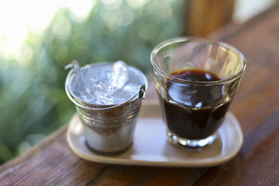 Selective focus metal ice cup with hot americano black coffee looks beautiful 