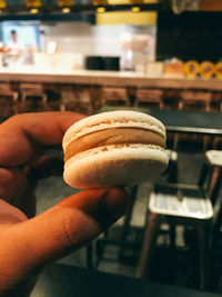 Close-up of hand holding macaron
