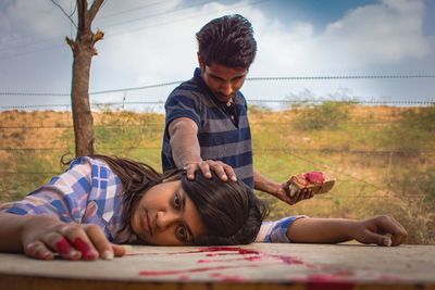 Father and girl playing with baby in farm