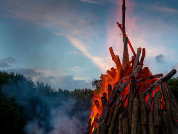 Low angle view of bonfire against sky