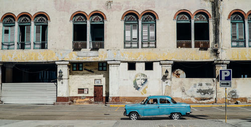 Car on street against buildings in city