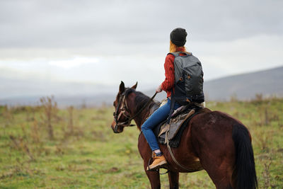 Man riding horse on field