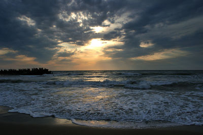 View of sea against cloudy sky during sunset