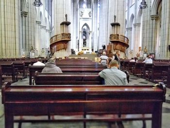 Rear view of people sitting in temple