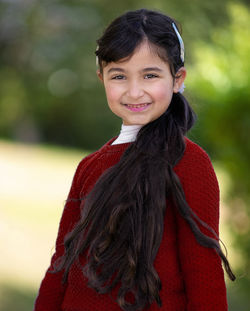 Portrait of smiling woman standing outdoors