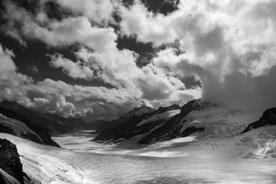 Scenic view of snowcapped mountains by sea against sky