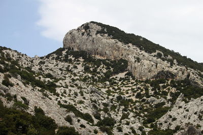 Low angle view of rocky mountains against sky