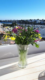 Flower vase on table against clear sky