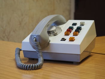 Close-up of old-fashioned telephone on wooden table