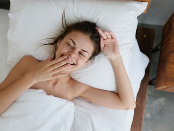 Young woman sleeping on bed at home