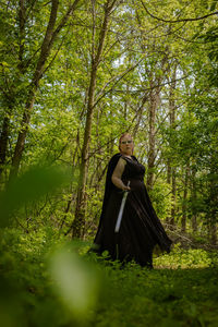 Young woman standing in forest