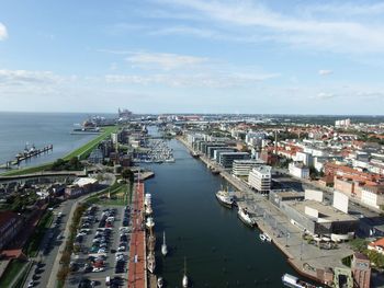 High angle view of buildings by sea against sky