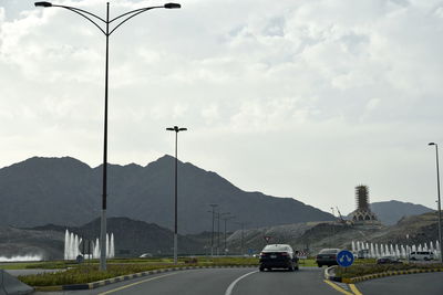 Cars on road against sky