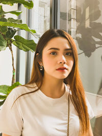 Portrait of beautiful young woman sitting at home