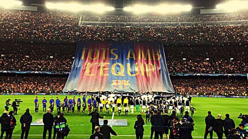 Crowd on soccer field at night