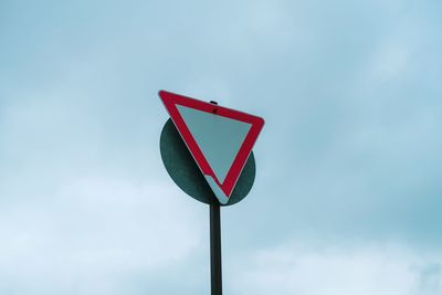 Low angle view of road sign against sky