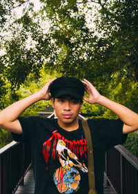 Portrait of boy standing by railing