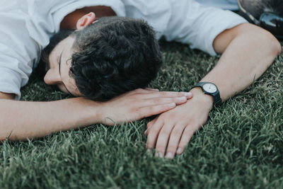 High angle view of man sleeping on grass