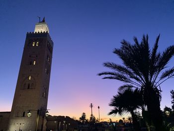 Low angle view of silhouette building against sky