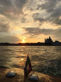 Boat in sea at sunset