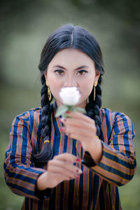 Portrait of smiling young woman blowing bubbles