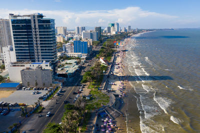 High angle view of buildings by sea against sky