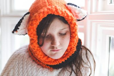 Close-up of cute girl wearing knitted headwear