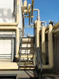 Low angle view of pipes against sky