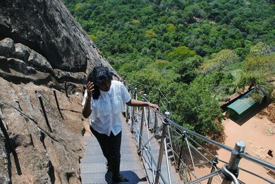 High angle view of girl on steps at mountain