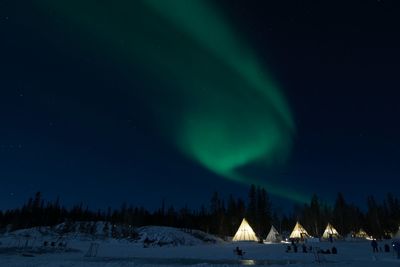 Scenic view of snowcapped mountains against sky at night