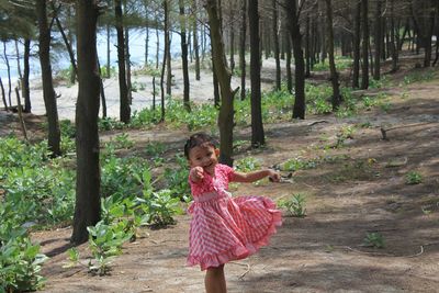 Cute girl standing in forest