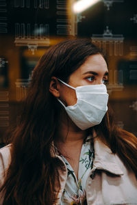 Portrait of woman wearing a face mask in an underground train