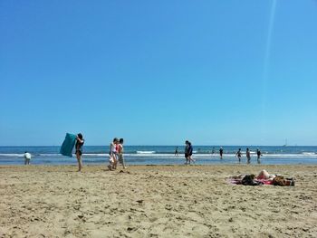 Scenic view of beach against blue sky