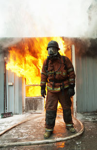 Fire fighter in front of burning buildings