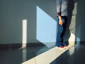 Low section of man wearing shoes