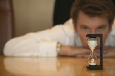 Portrait of man holding wineglass on table