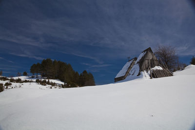 Snow covered land against sky