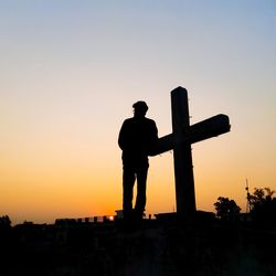 Silhouette man standing against clear sky during sunset